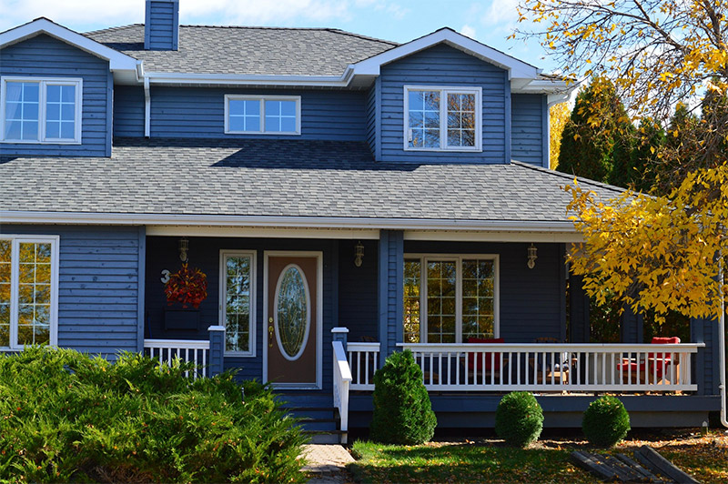 Modern suburban house representing window replacement services by local companies and big box retailers