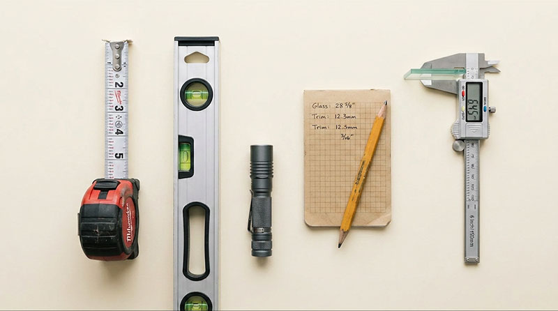 Essential tools for measuring windows accurately, including tape measure, level, and calliper