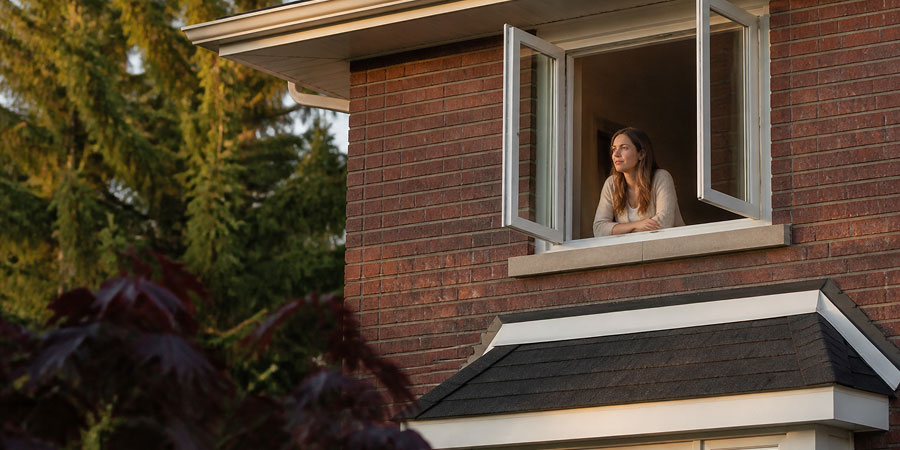 Opened windows with a happy homeowner